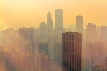 Chongqing, China - March 22, 2018: Blurred cityscape in sunset haze. Marriott Hotel Building in the Chinese city of Chongqing.