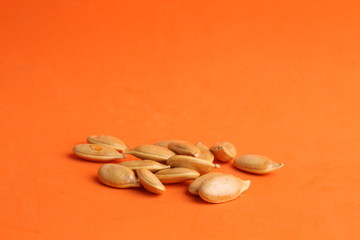 pumpkin seeds on color background