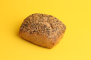 delicious bread rolls on colored background