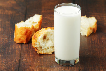 A glass of milk and wheat bread as countryside breakfast	