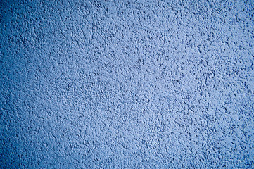 Wall of blue rough embossed building decorative stucco. Texture, background