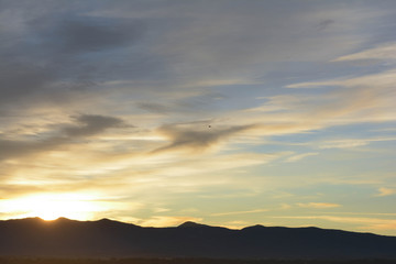 The sun rising over the mountains during a sunrise