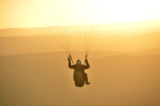 Paraglider flying in a spectacular sunset