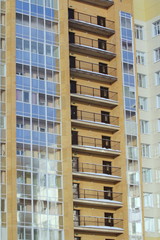 Fototapeta na wymiar Plastic windows in a modern tiled brick high-rise house.