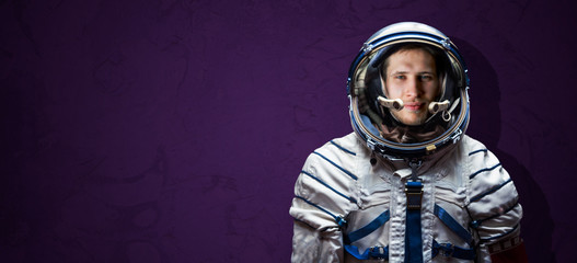 isolated simple astronaut uniform, scafandr and mask against the color wall background, wide banner. elements of this image furnished by nasa