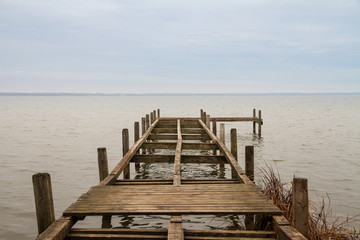 wooden dock with missing planks at lake steinhude in germany