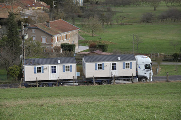 Two mobile homes on a truck 
