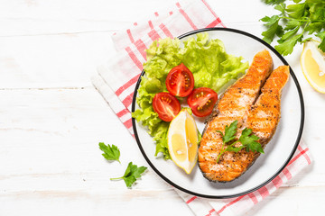 Grilled salmon fish steak on white.