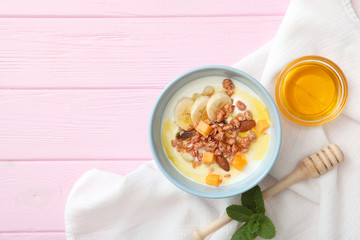 Yogurt with fruits, granola and nuts on the table top view. Healthy breakfast, natural yogurt.