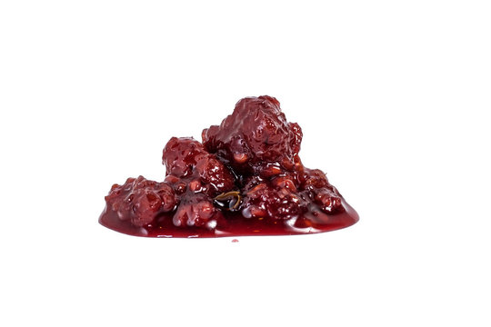 Splash of red raspberry jam on a white background