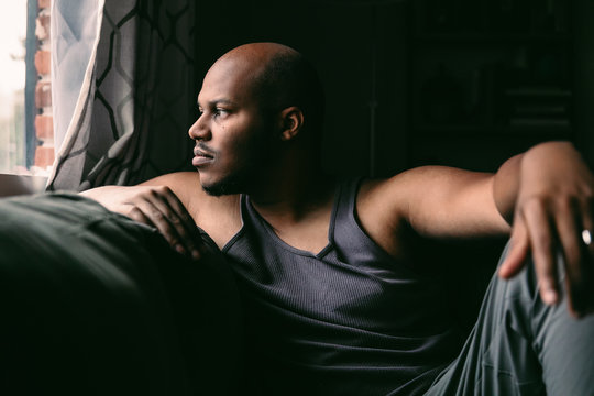 Man looking out window at home