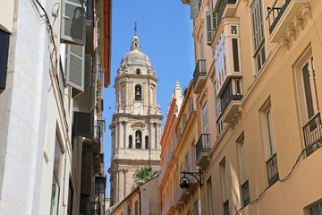 Looking towards the Cathedral through the city narrow streets, in the downtown, Malaga,  Andalusia, Southern Spain.
