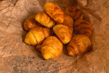 Several mini croissants on the a sales paper