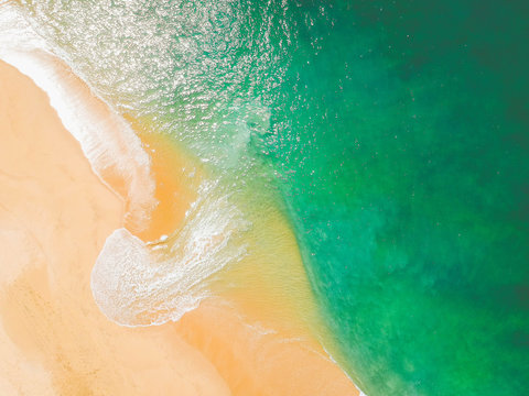 Aerial Drone Shot of ocean and sandy beach Green Torquoise