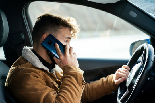 Person using his smartphone in his car