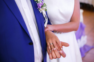 bride holds the groom by the elbow