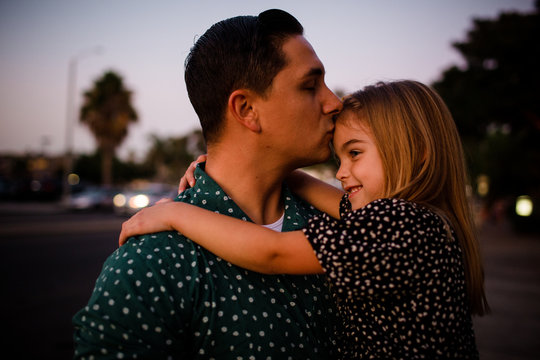 Father Kissing Daughter on Forehead