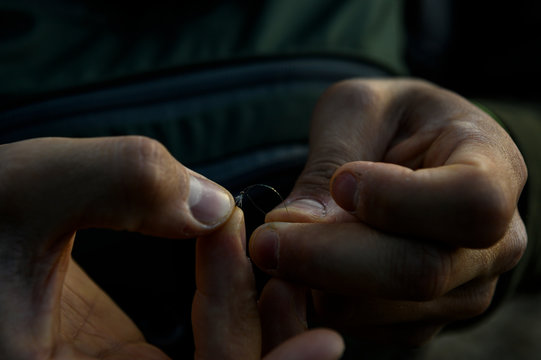 A fly fisherman ties on a tiny fly to tippet.