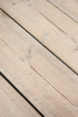 Background for collage, website or blog - wooden natural not painted smooth boards at an angle.
