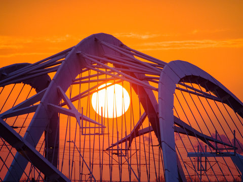 A modern steel bridge over the Ij Meer to ijburg, Amsterdam, Netherlands at sunset.