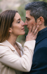 Fototapeta premium Young couple kissing with complicity