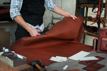 Master sewing leather goods, concept of handmade craft production