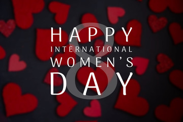 Happy International Women's Day lettering with white text on black background with red heart