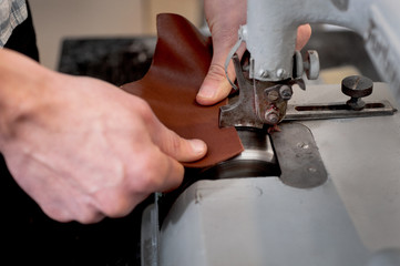 masters hands work with grinding leather products