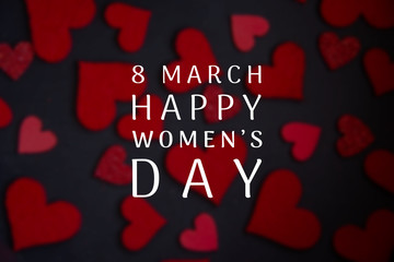 Happy International Women's Day lettering with white text on black background with red heart