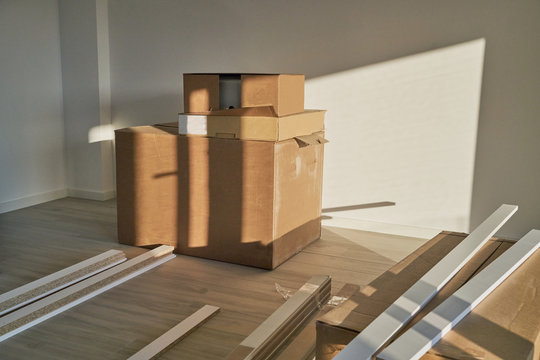 Spacious empty floor living room with a stack of boxes and reform tables. Housing preparing to furnish