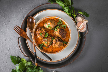 Tasty homemade meatballs with tomato sauce and herbs served in a plate