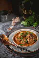 Tasty homemade meatballs with tomato sauce and herbs served in a plate