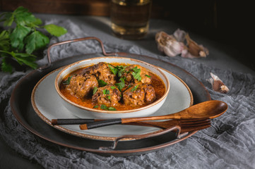 Tasty homemade meatballs with tomato sauce and herbs served in a plate