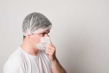 Doctor in a medical mask and hat. Man in a medical mask. Doctor man in a medical mask.