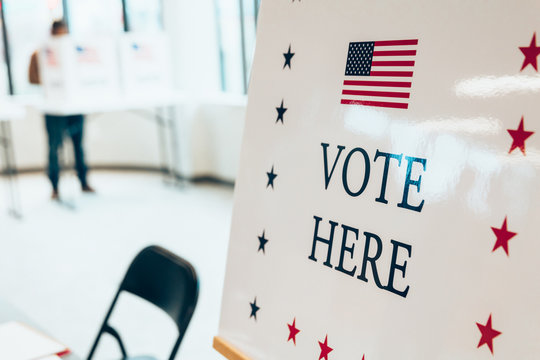 Close up of vote here sign