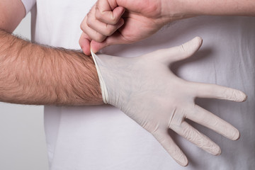 Fototapeta premium Doctor in surgical gloves. Surgeon before the operation. Male hand in latex glove.
