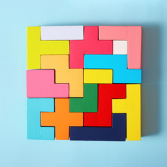 Wooden tangram cubes as a symbol of riddle