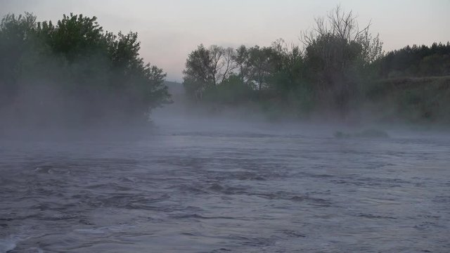 Powerful river in the morning fog. Morning twilight before sunrise on river. 4K