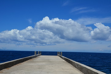  pier stretches to the sea of against blue sky