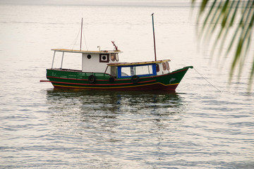 Fototapeta premium hing boats anchored in the river, floating peacefully in harbor.