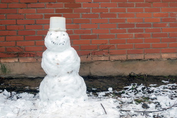 Snowman molded from the first snow in the park.
