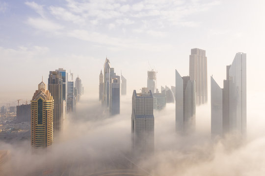 Aerial view of buildings surrounded by clouds Dubai, United Arab Emirates