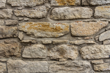 Ancient masonry wall. Wall of an ancient castle in the old city. Good stone texture
