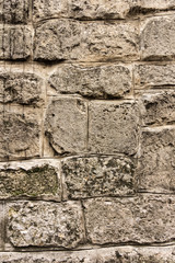 Ancient masonry wall. Wall of an ancient castle in the old city. Good stone texture