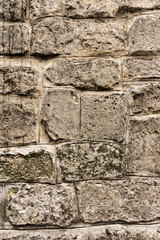 Ancient masonry wall. Wall of an ancient castle in the old city. Good stone texture