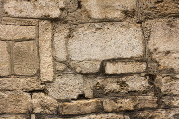 Ancient masonry wall. Wall of an ancient castle in the old city. Good stone texture