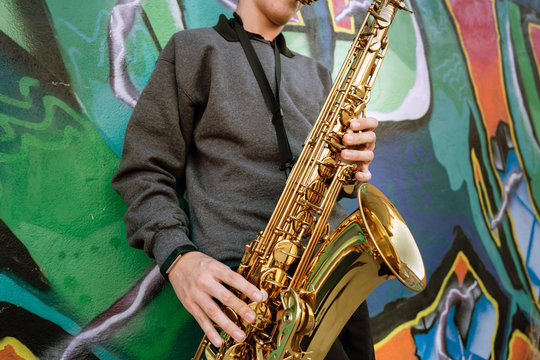 High School Band Musician Playing Saxophone By Graffiti, Mid Section