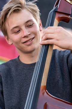High school jazz band musician playing double bass