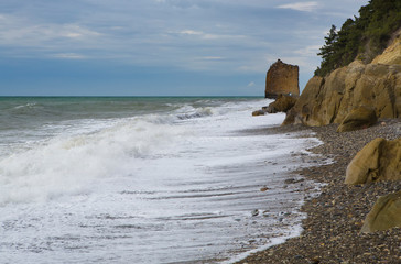 A rock in the shape of a sail on the black sea coast of Russia near the village of Praskoveyevka. Winter, storm, waves