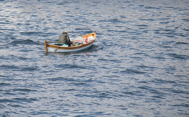 Fototapeta na wymiar Boat close-up on the sea. An old person on the boat.